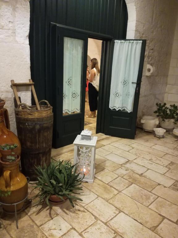 a woman taking a picture of a woman standing at the door at Masseria Asciano in Ostuni