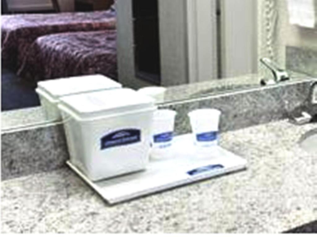 a bathroom counter with two hygiene products on it at Howard Johnson by Wyndham Commerce GA in Commerce