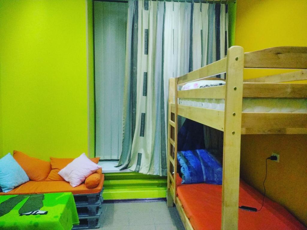 a room with a bunk bed and a couch at Yourhostel Дорогожичи in Kyiv