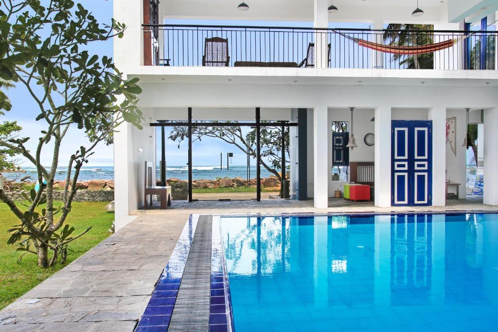 an external view of a house with a swimming pool at Culture Resort in Matara