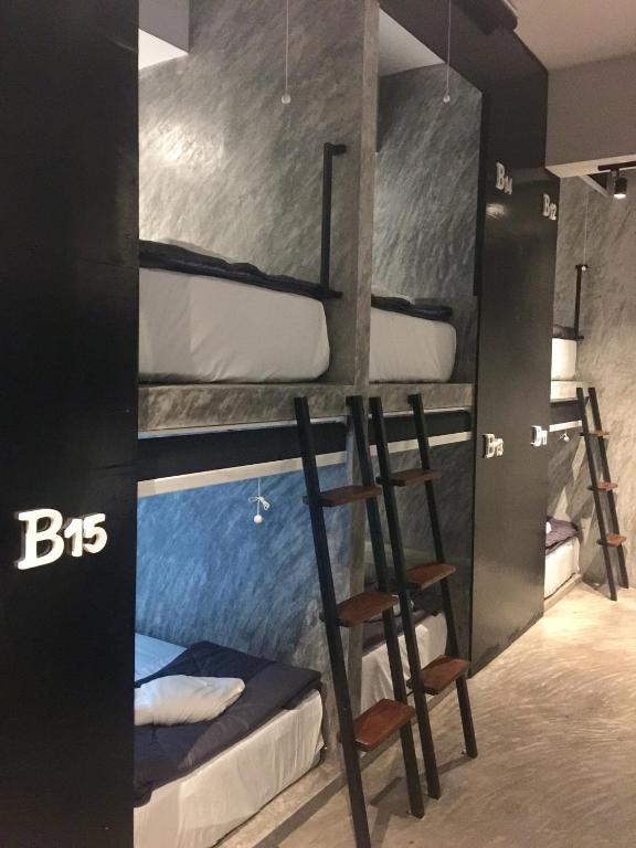 a room with a bunch of bunk beds at Nirvana Guesthouse & Hostel in Koh Tao