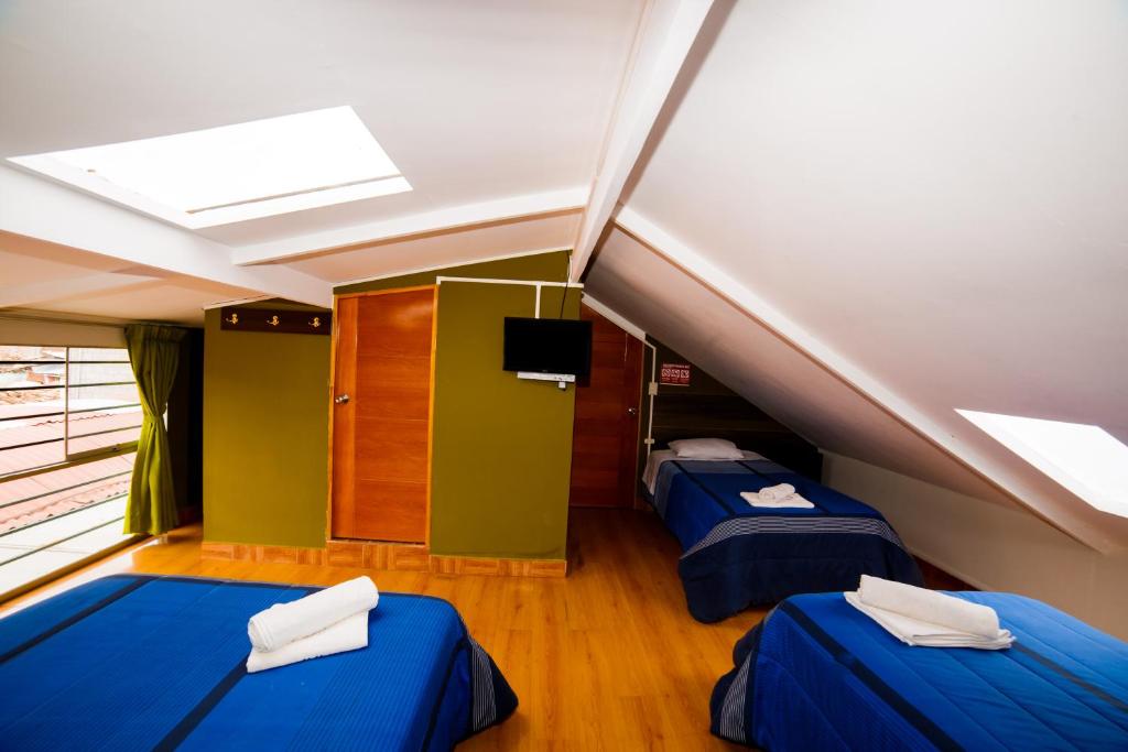 Postel nebo postele na pokoji v ubytování Ukukus Hostel