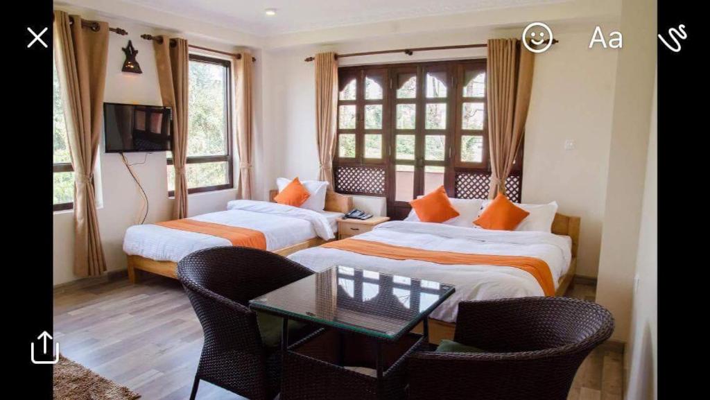A bed or beds in a room at Dhulikhel boutique hotel