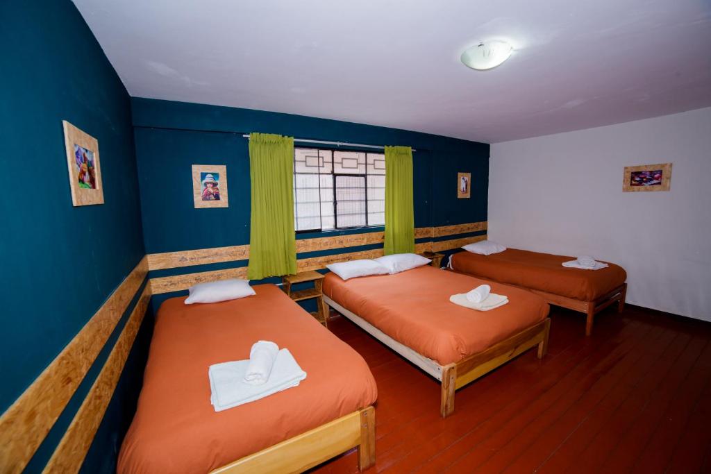 Postel nebo postele na pokoji v ubytování Ukukus Hostel