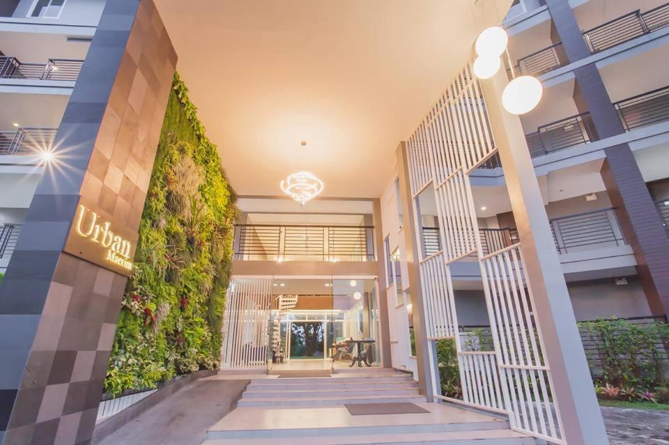 a lobby of a building with a plant at Urban Maerim in Mae Rim