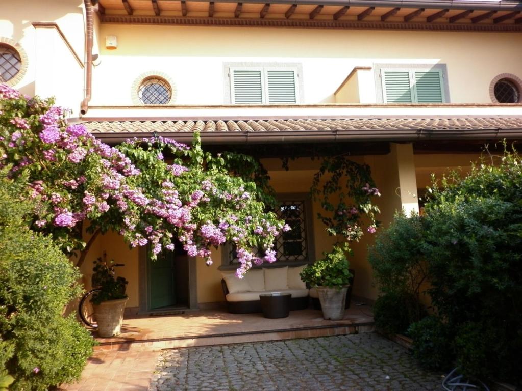uma casa com flores em frente em Deliziosa Villetta em Forte dei Marmi