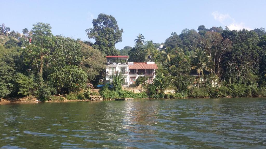 a house on the banks of a river at Chaminrich Homestay in Kandy