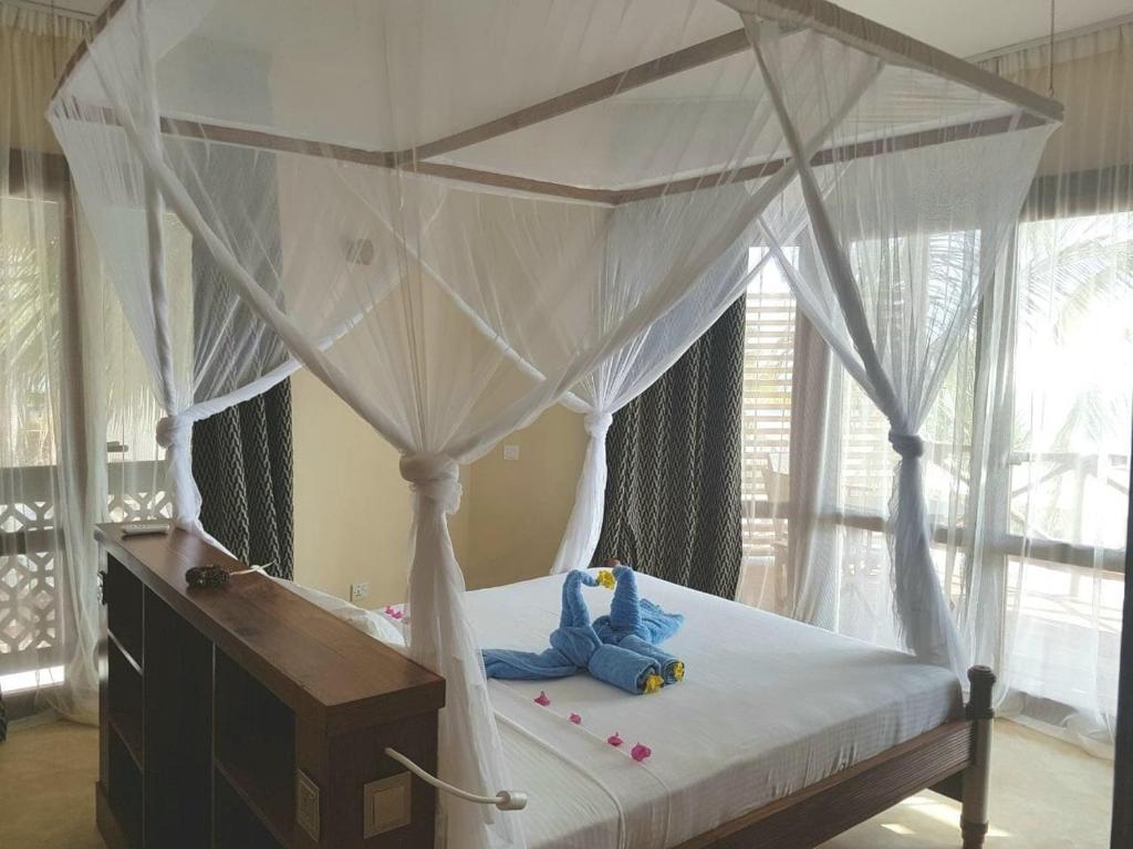 Postel nebo postele na pokoji v ubytování Zanziblue Boutique Villas