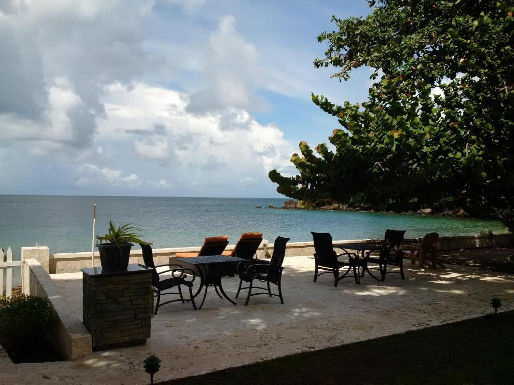 a group of chairs and a table on the beach at Sunset Shores Beach Hotel in Kingstown