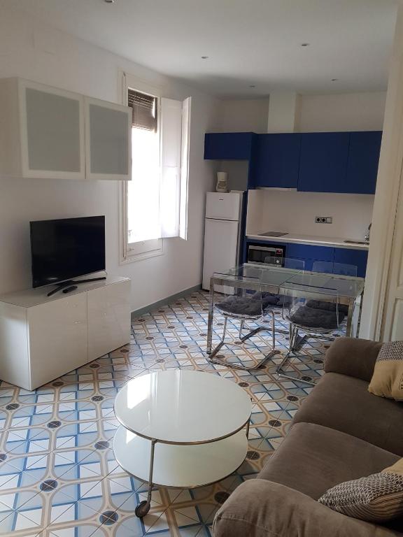 TV a/nebo společenská místnost v ubytování Apartamentos Nouvilas