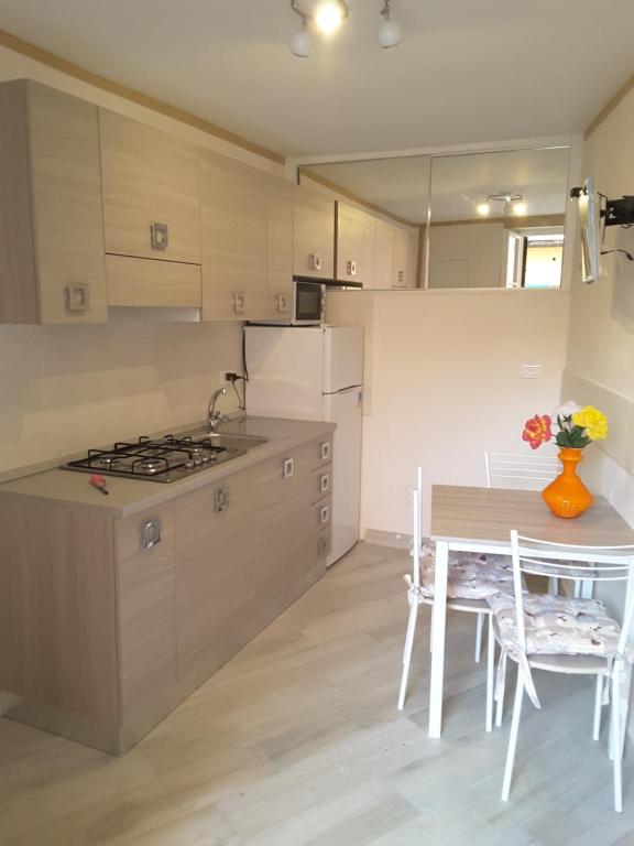 a kitchen with a table and a stove at Appartamento Poggio Romantico Andrea in Marciana