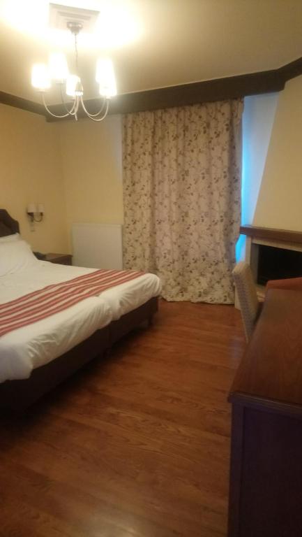 Postel nebo postele na pokoji v ubytování Hotel Pelasgos