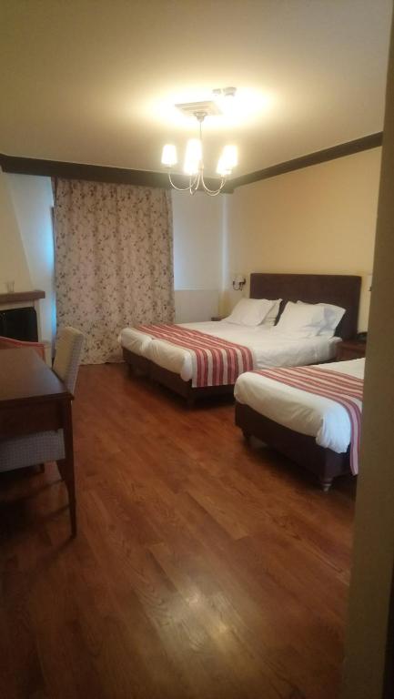 Postel nebo postele na pokoji v ubytování Hotel Pelasgos