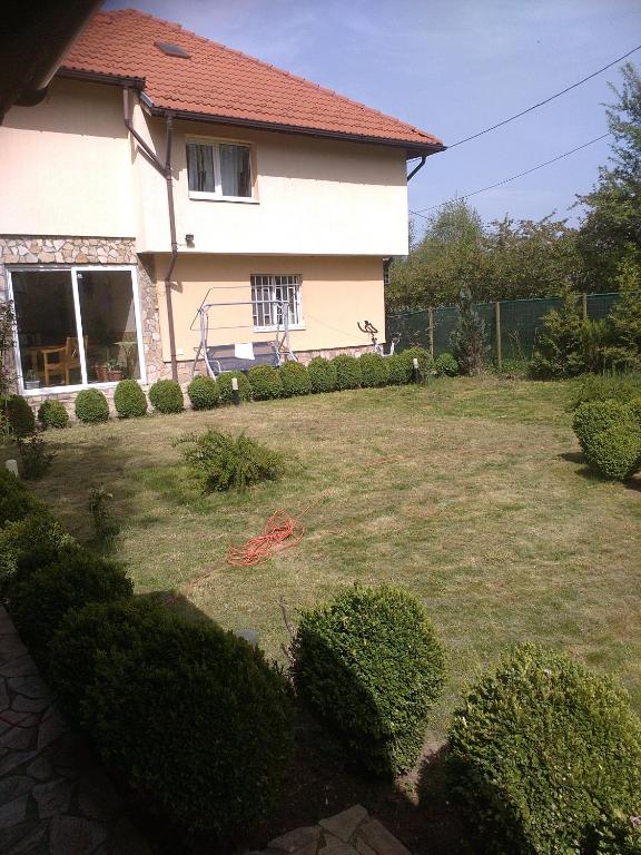 a house with a yard with hedges at Guest House Iveta in Sofia