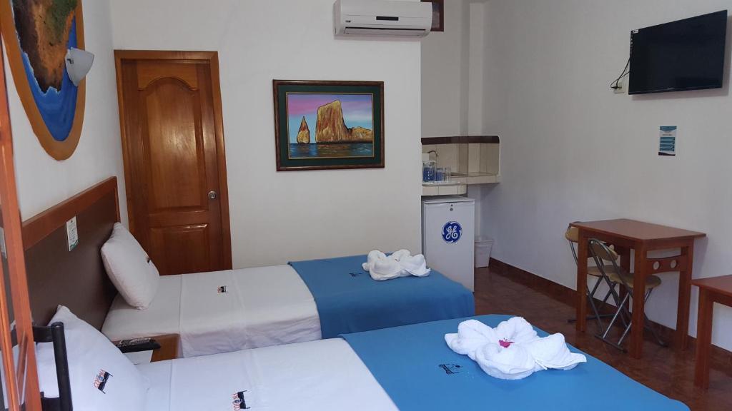 Postel nebo postele na pokoji v ubytování Hotel Coloma Galapagos