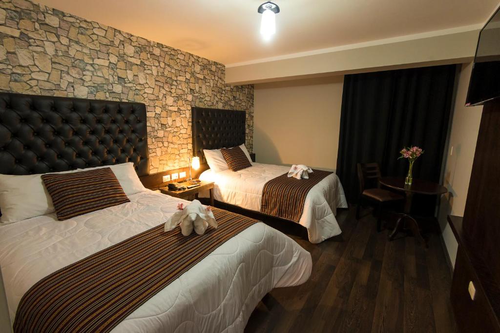 Katil atau katil-katil dalam bilik di Ureta Hotel