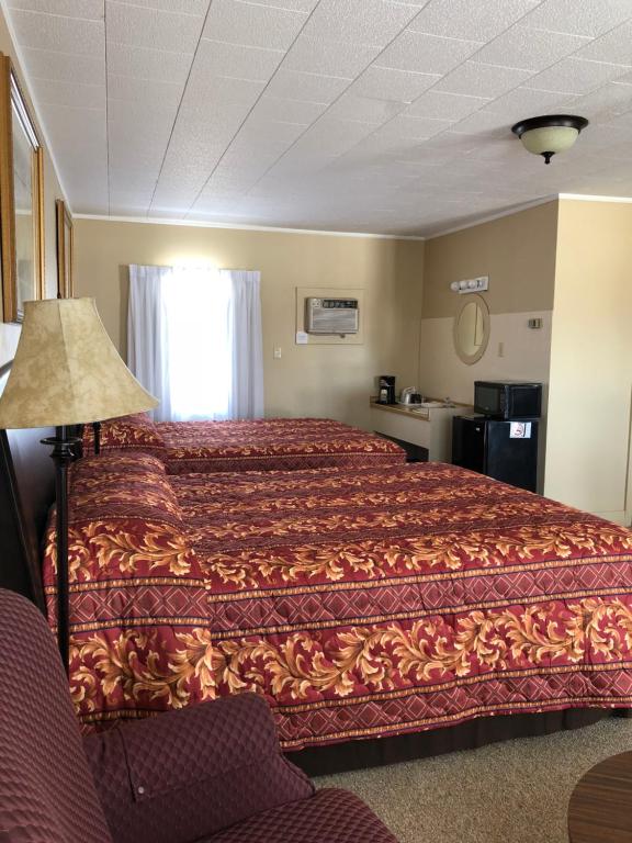 Postel nebo postele na pokoji v ubytování Dunlop Motel