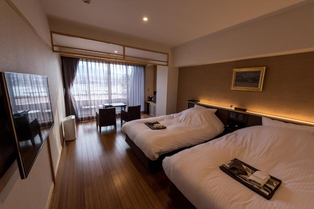 Ein Bett oder Betten in einem Zimmer der Unterkunft Mizno Hotel