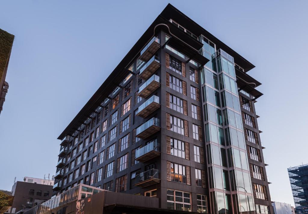 a tall black building with many windows at Museum Apartment Hotel, Independent Collection by EVT in Wellington