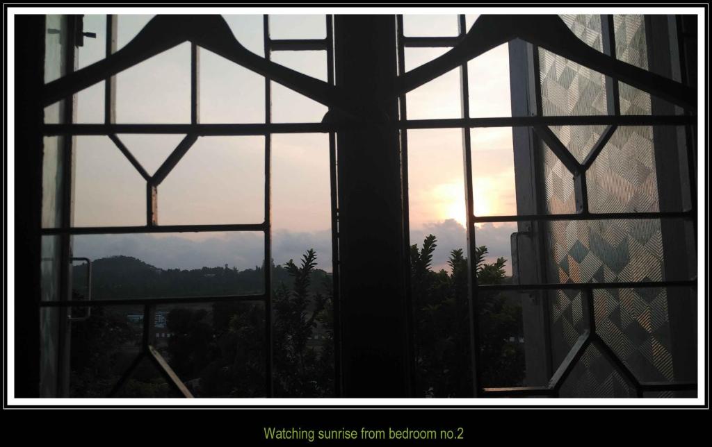 an open window with a view of a mountain view at The Lagoon shade in Port Blair