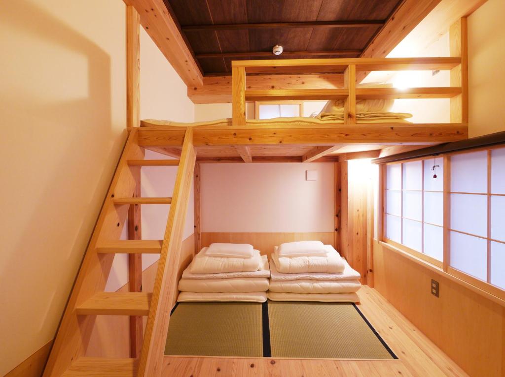 a loft bed in a tiny house at Poly Hostel 2 Namba in Osaka