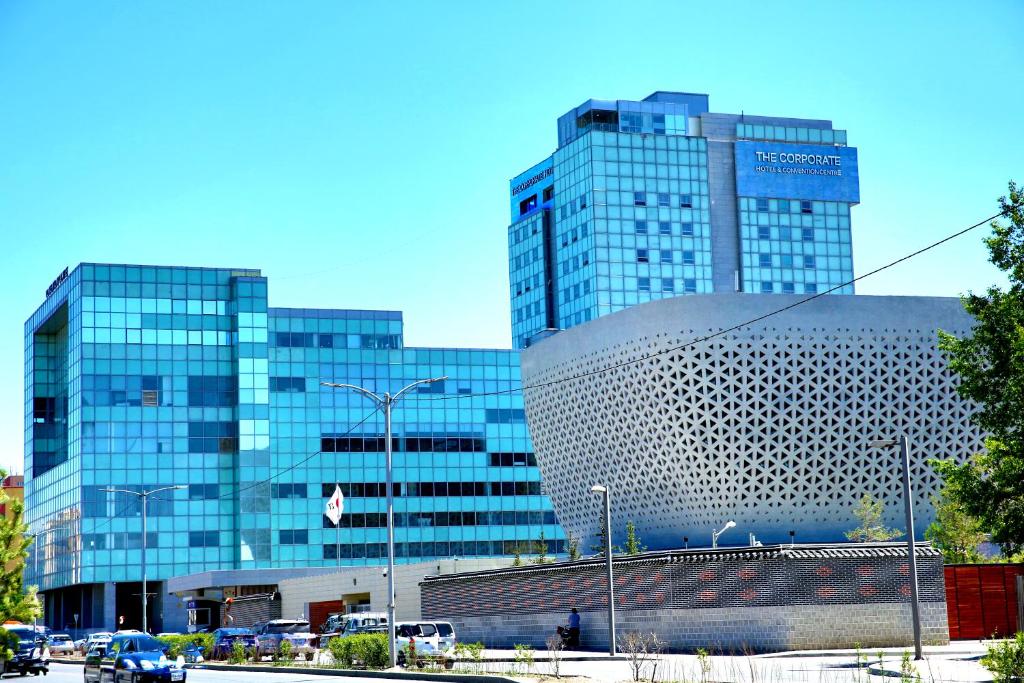 a group of tall glass buildings in a city at The Corporate Hotel and Convention Centre in Ulaanbaatar