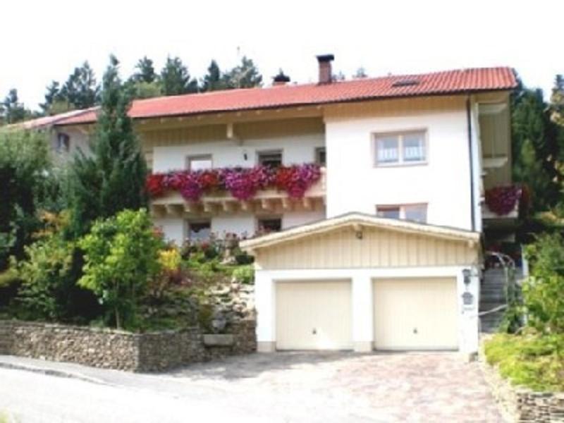 a large white house with two garage doors at Haus Bergblick Bay. Wald in Prackenbach