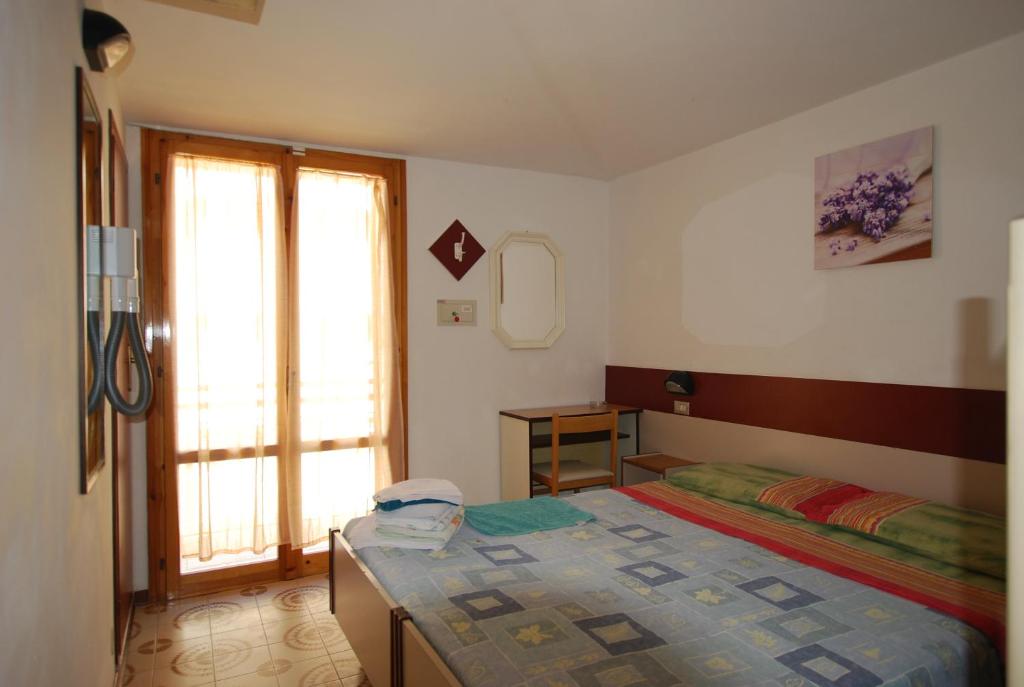 Postel nebo postele na pokoji v ubytování Hotel Cesari
