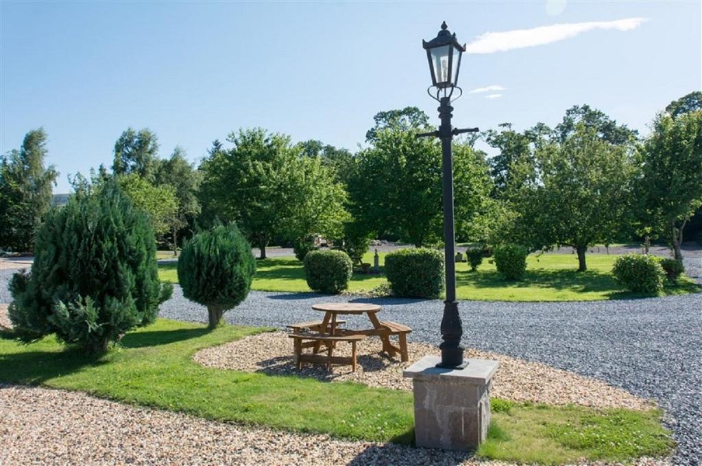 a park with a picnic table and a street light at Tweed Lodge in Perth