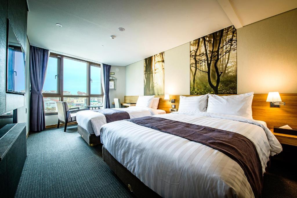 Postel nebo postele na pokoji v ubytování Utop Ubless Hotel Jeju