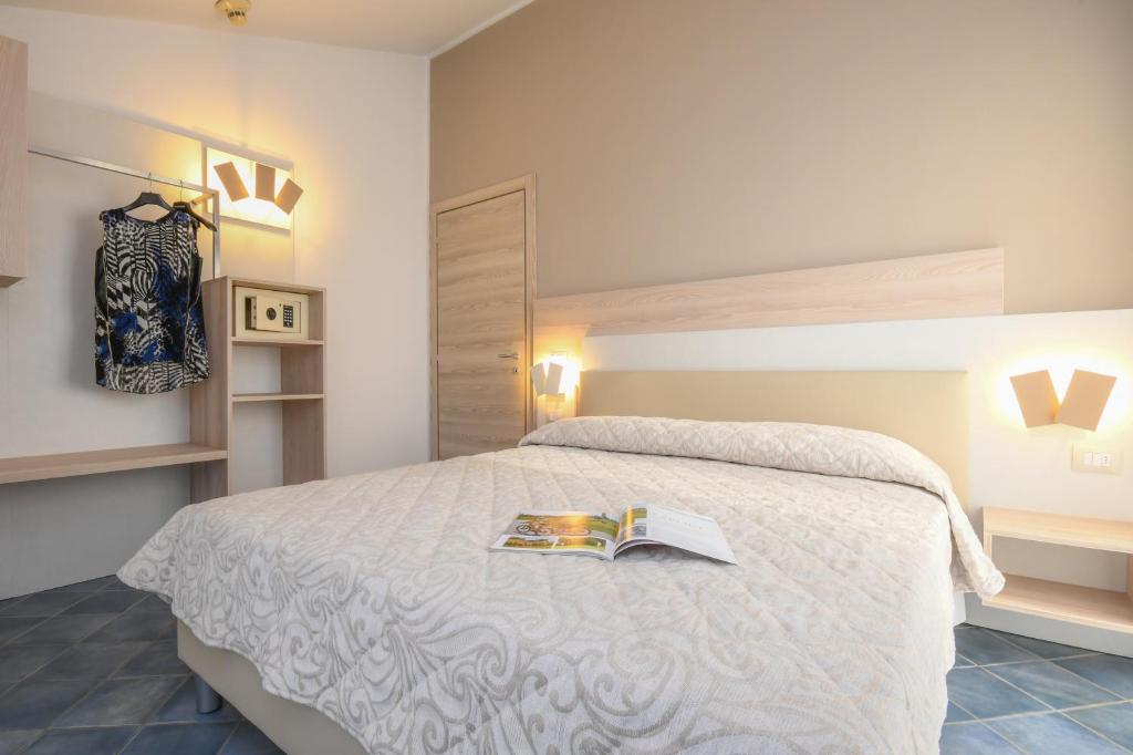 Postel nebo postele na pokoji v ubytování Hotel Riel
