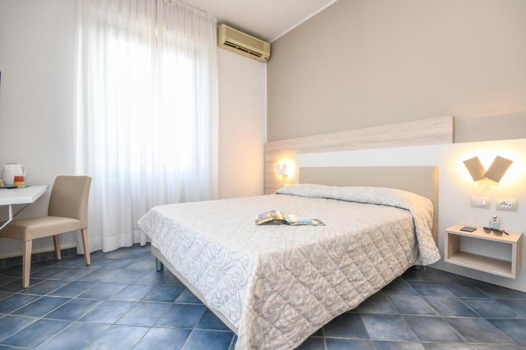 Postel nebo postele na pokoji v ubytování Hotel Riel