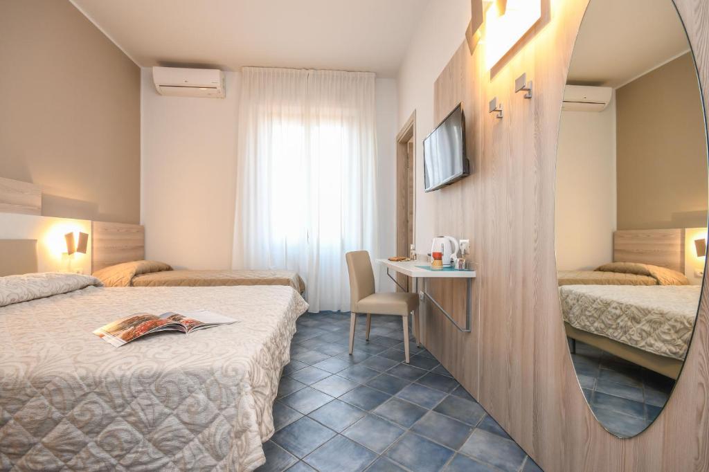 Postel nebo postele na pokoji v ubytování Hotel Riel