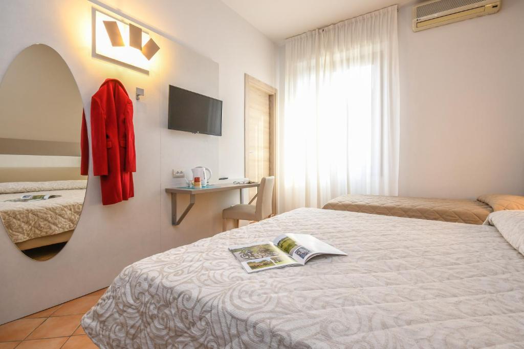 Postel nebo postele na pokoji v ubytování Hotel Riel