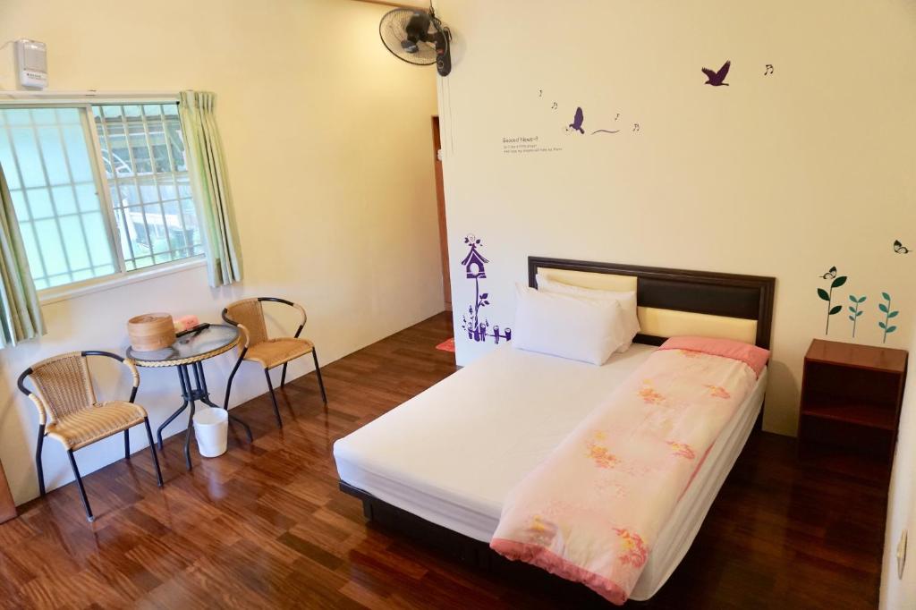 Postel nebo postele na pokoji v ubytování Chin Shan B&B