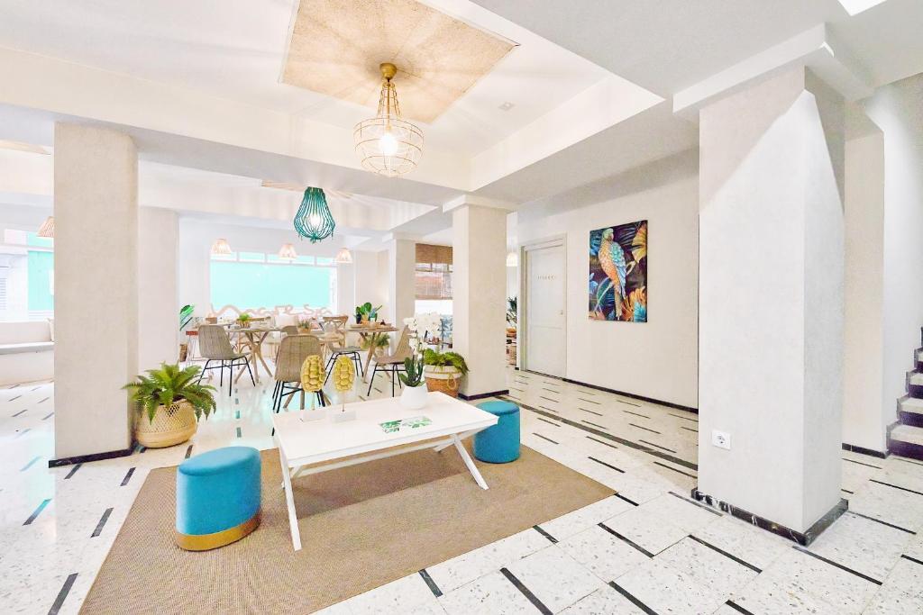 a living room with a table and a dining room at Maresía Canteras Urban Hotel in Las Palmas de Gran Canaria