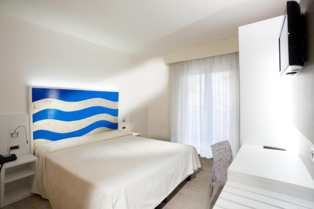Postel nebo postele na pokoji v ubytování Hotel Savoy