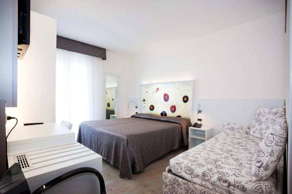 Postel nebo postele na pokoji v ubytování Hotel Savoy