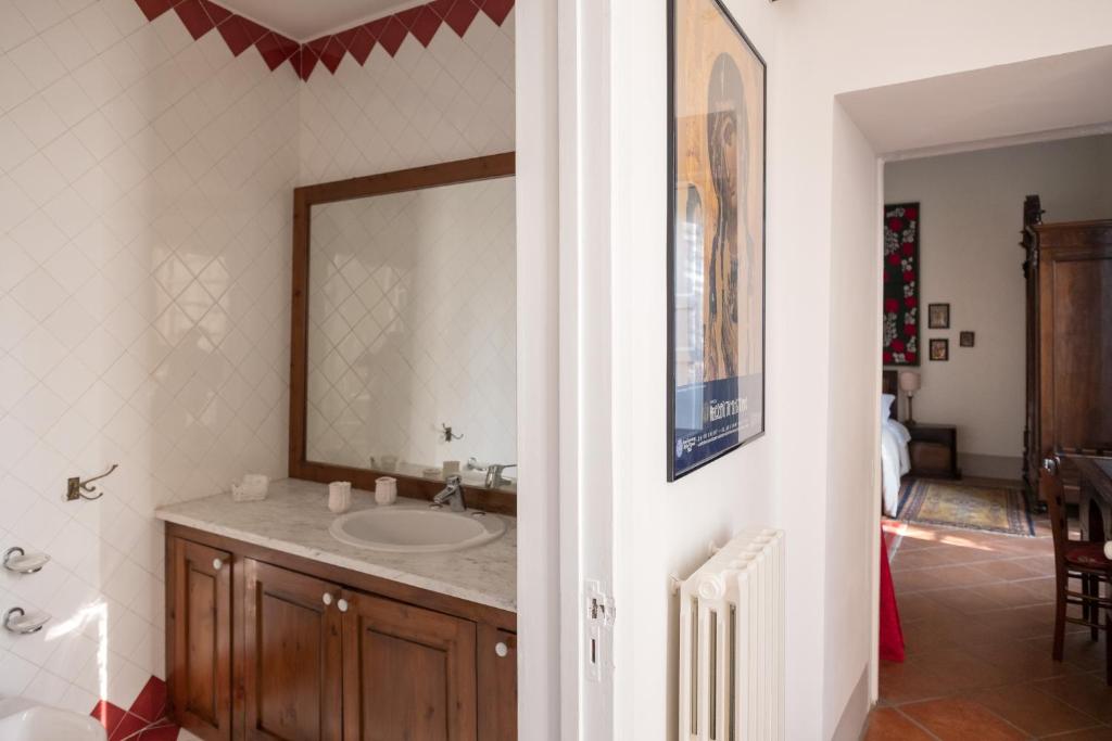 a bathroom with a sink and a mirror at Palazzo Bernardini Suites in Lecce