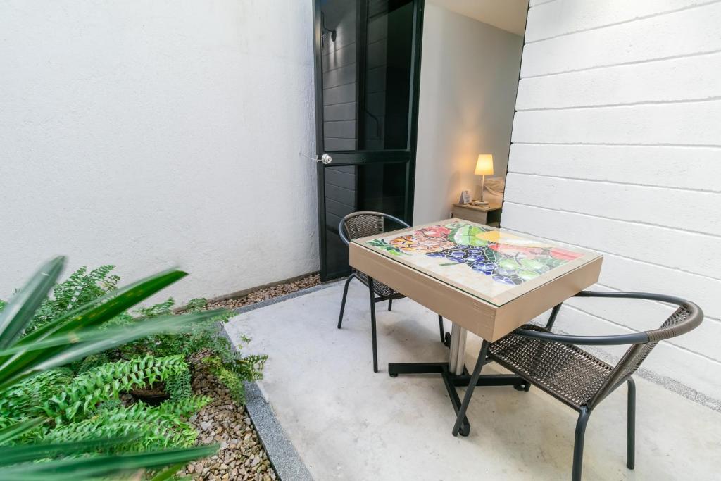 a table and two chairs sitting on a patio at Hotel Casa Vallecaucana in Cali
