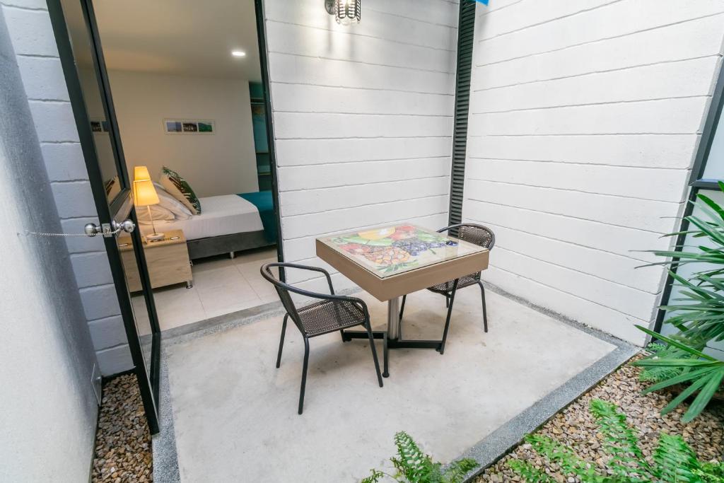 a small table and two chairs on a patio at Hotel Casa Vallecaucana in Cali