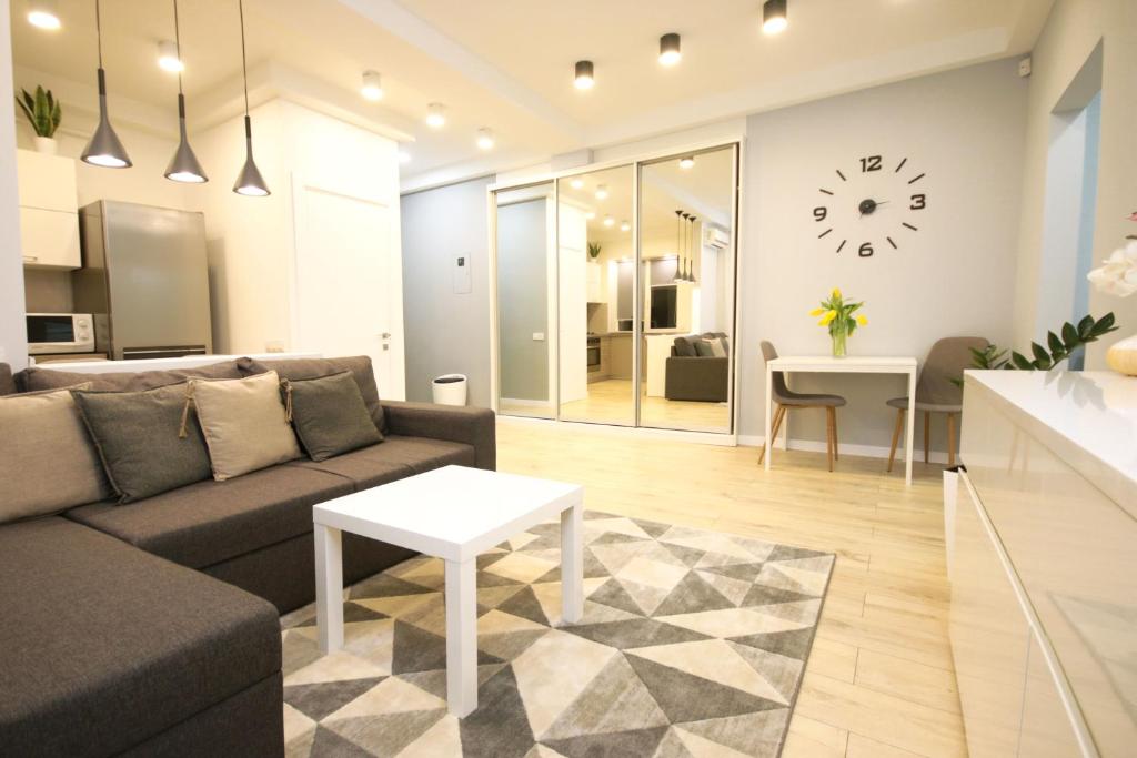 a living room with a couch and a table at Inn Home Apartments - Ocean Plaza area in Kyiv