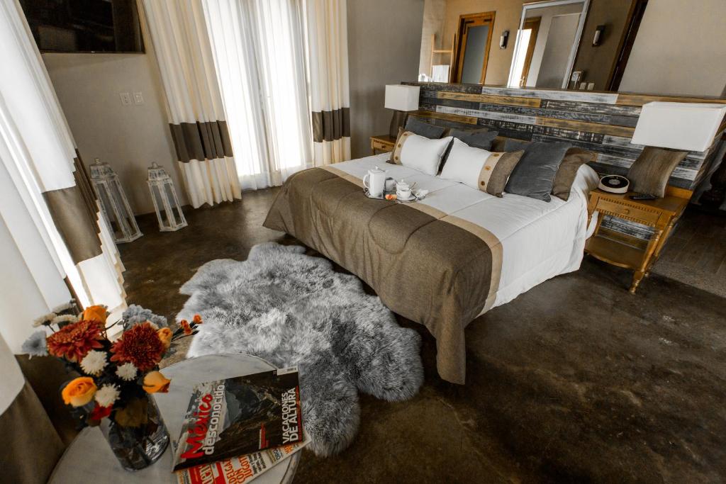 a bedroom with a large bed and a teddy bear at Casa Legado in Aguascalientes