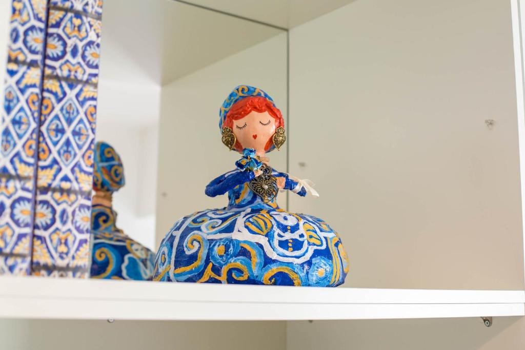 a shelf with two blue and white vases on it at Almada Story Apartments by Porto City Hosts in Porto