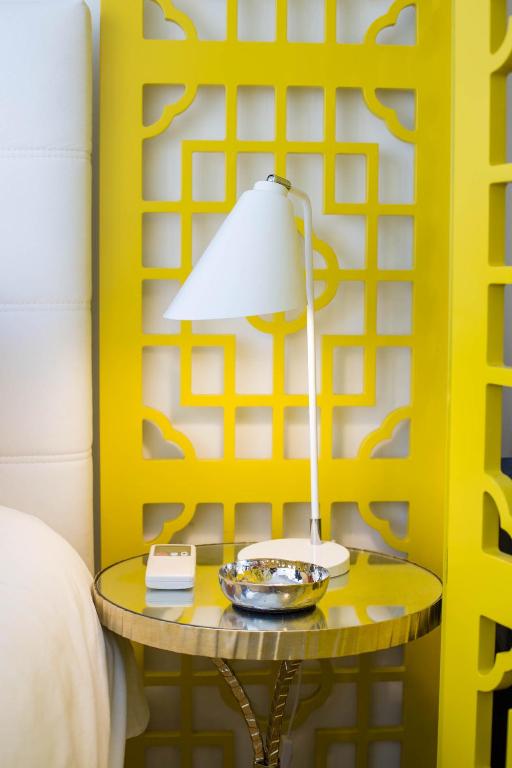 a lamp on a table next to a bed at Almada Story Apartments by Porto City Hosts in Porto
