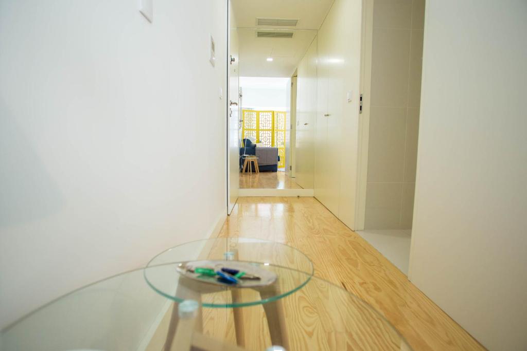 a glass table in the middle of a room at Almada Story Apartments by Porto City Hosts in Porto