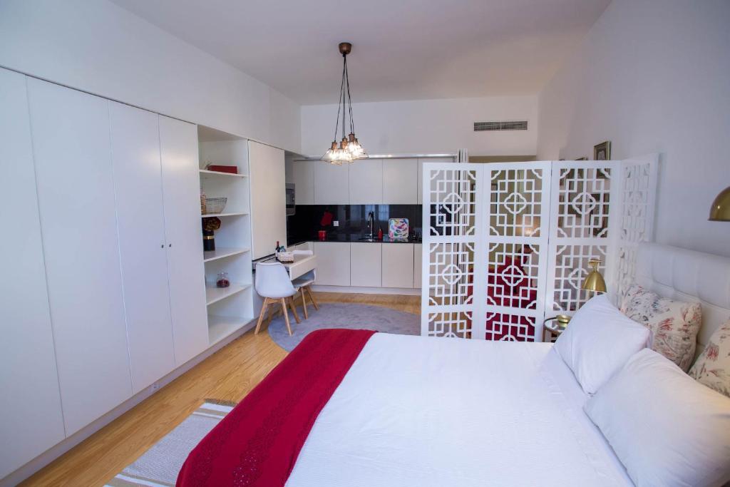 a white bedroom with a bed and a desk at Almada Story Apartments by Porto City Hosts in Porto