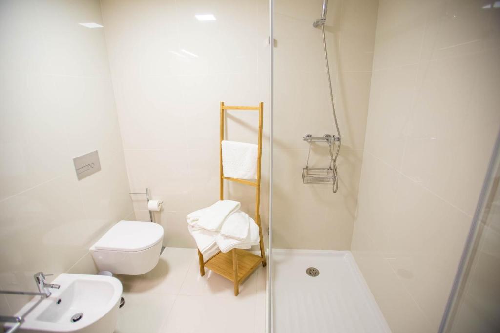 a bathroom with a toilet and a sink and a shower at Almada Story Apartments by Porto City Hosts in Porto