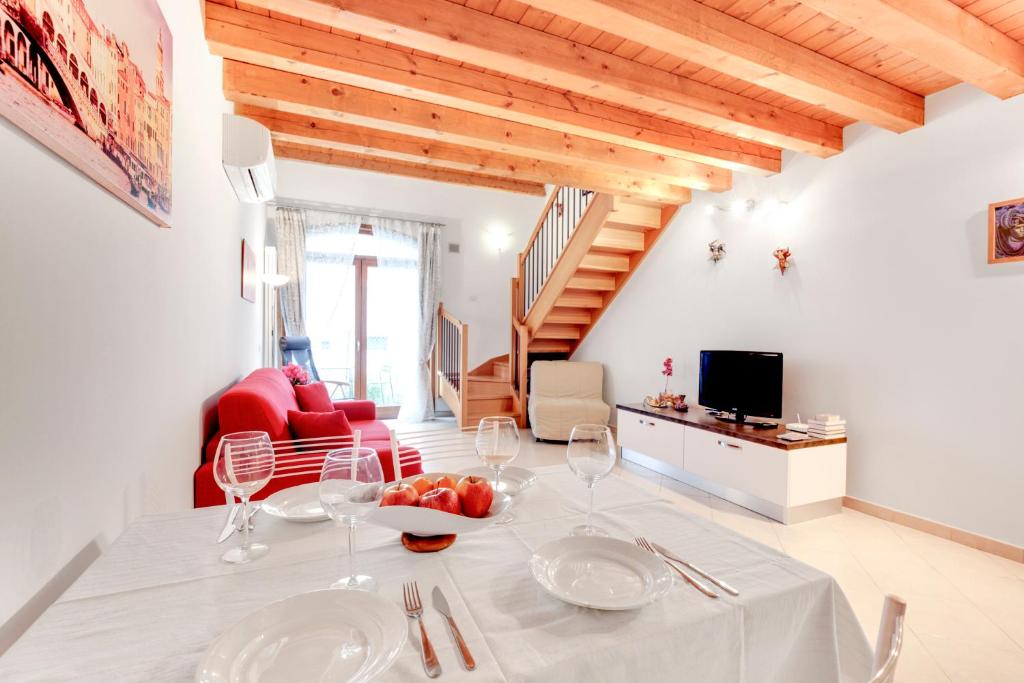 une salle à manger blanche avec une table et des verres à vin dans l'établissement Little canal 8, à Venise
