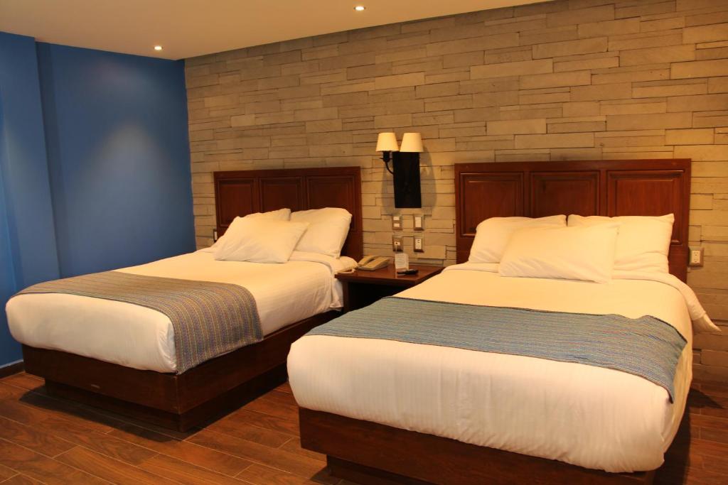 Postel nebo postele na pokoji v ubytování Hotel Alameda Centro Historico